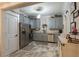 Updated kitchen showcasing gray cabinets, granite countertops, and a stainless steel refrigerator at 7308 York, Mebane, NC 27302
