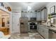 Charming kitchen featuring updated appliances, gray cabinets, and stylish flooring at 7308 York, Mebane, NC 27302