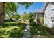 Well-maintained landscaping featuring green grass, stone path, mature trees, and lush greenery at 7308 York, Mebane, NC 27302