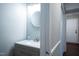 Charming bathroom with a granite vanity, round mirror, and neutral-toned walls at 861 Dalewood Dr, Raleigh, NC 27610