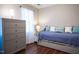 Well-lit bedroom features wood floors, large window and a daybed at 861 Dalewood Dr, Raleigh, NC 27610