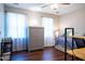 Well-lit bedroom features wood floors, two large windows and a gray chest of drawers at 861 Dalewood Dr, Raleigh, NC 27610