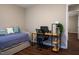 Cozy bedroom with wood floors features a daybed and workspace at 861 Dalewood Dr, Raleigh, NC 27610