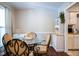 Bright dining room with dark flooring featuring a round table, hutch, and natural light at 861 Dalewood Dr, Raleigh, NC 27610