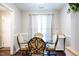 Cozy dining room featuring a round glass table, elegant chairs, and bright natural light at 861 Dalewood Dr, Raleigh, NC 27610