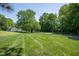 Expansive front yard with mature trees and neatly striped lawn on a quiet street at 861 Dalewood Dr, Raleigh, NC 27610