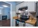 Efficient kitchen with wood countertops, stainless steel oven, and easy access to the living area at 861 Dalewood Dr, Raleigh, NC 27610