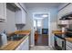 Functional kitchen featuring stainless steel sink, butcher block countertops, and backyard views at 861 Dalewood Dr, Raleigh, NC 27610