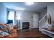 Inviting living room featuring a cozy fireplace, comfortable seating, and staircase access at 861 Dalewood Dr, Raleigh, NC 27610