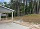 Backyard featuring a covered patio and a view of the woods beyond the lot at 1003 Shovelhead Dr # 2, Durham, NC 27703
