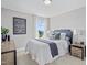 Comfortable bedroom with stylish decor, a plush bed, and scenic outdoor views at 1003 Shovelhead Dr # 2, Durham, NC 27703
