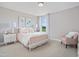 Cozy bedroom with charming decor, a cushioned chair, and natural light from the window at 1003 Shovelhead Dr # 2, Durham, NC 27703