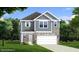 Charming two-story home features a stone and siding facade, green lawn and attached two car garage at 1003 Shovelhead Dr # 2, Durham, NC 27703