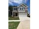Two-story home featuring a two-car garage, stone accents, gray siding, and a well-manicured front yard at 1003 Shovelhead Dr # 2, Durham, NC 27703