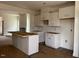 Spacious kitchen with white cabinets, large island, and an open floor plan to the living room at 1003 Shovelhead Dr # 2, Durham, NC 27703