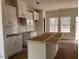 Kitchen with stainless appliances, white cabinets, island, and a tile backsplash at 1003 Shovelhead Dr # 2, Durham, NC 27703