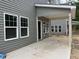 Covered patio with gray siding, gray support pillars, and a view of another house at 1003 Shovelhead Dr # 2, Durham, NC 27703