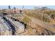 An aerial view captures modern townhomes next to city skyline and roads filled with trees at 1012 Manor Way, Durham, NC 27701