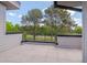 A balcony with tile flooring and a black metal railing offers a view of the surrounding trees at 1012 Manor Way, Durham, NC 27701