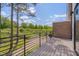 Relax on the private balcony featuring wood floors and metal railings with scenic outdoor views at 1012 Manor Way, Durham, NC 27701