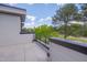 A modern, tiled balcony boasts sleek lines and a scenic view of lush greenery and blue skies at 1012 Manor Way, Durham, NC 27701