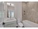 Modern bathroom featuring a tiled shower, vanity with storage, and toilet at 1012 Manor Way, Durham, NC 27701