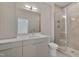 Bathroom features a glass shower, white countertops, wood cabinets, and a vanity mirror at 1012 Manor Way, Durham, NC 27701