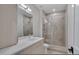 Modern bathroom features a glass shower, white countertops, and wood cabinets at 1012 Manor Way, Durham, NC 27701