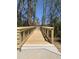 Wooden walking bridge featuring metal rails leading to a building in a landscaped area on a clear day at 1012 Manor Way, Durham, NC 27701