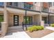 Brick townhome entrance with a modern front door and manicured landscaping at 1012 Manor Way, Durham, NC 27701
