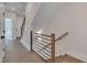 View of a hallway featuring a stairwell with wood and metal railing and hardwood floors at 1012 Manor Way, Durham, NC 27701