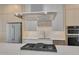 Sleek kitchen with modern stainless steel appliances and cooktop island at 1012 Manor Way, Durham, NC 27701