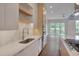 Bright, modern kitchen features a stainless steel sink, appliances, and a sleek backsplash at 1012 Manor Way, Durham, NC 27701