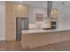 Bright kitchen with an island cooktop, stainless appliances, and stylish, contemporary cabinets at 1012 Manor Way, Durham, NC 27701