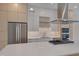 Modern kitchen with a quartz countertop island, stainless steel appliances, and stylish backsplash at 1012 Manor Way, Durham, NC 27701