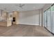 Bright living room with kitchen and balcony access, ceiling fan, and hardwood floors at 1012 Manor Way, Durham, NC 27701