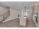 Open-concept living room with hardwood floors, stairs to second floor and kitchen at 1012 Manor Way, Durham, NC 27701