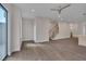 Open-concept living room featuring hardwood floors and staircase with metal railing at 1012 Manor Way, Durham, NC 27701