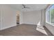 Spacious main bedroom featuring a ceiling fan, hardwood floors, and large windows for natural light at 1012 Manor Way, Durham, NC 27701