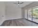 Spacious bedroom with hardwood floors, ceiling fan, and large sliding doors to balcony at 1012 Manor Way, Durham, NC 27701