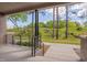 A covered patio with brickwork and metal railings overlooks a natural landscape, offering a serene outdoor space at 1012 Manor Way, Durham, NC 27701