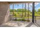 A covered patio with brickwork and metal railings overlooks a natural landscape, offering a serene outdoor space at 1012 Manor Way, Durham, NC 27701
