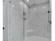 Luxury walk-in shower with marble tile, rainfall showerhead, and built-in shower seat at 1012 Manor Way, Durham, NC 27701