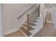 Stylish staircase with wooden steps, modern metal railing, and natural light at 1012 Manor Way, Durham, NC 27701