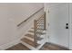 Modern staircase with wood treads, sleek railings, and natural light at 1012 Manor Way, Durham, NC 27701
