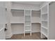 Well-organized walk-in closet with built-in shelving and rods for ample storage at 1012 Manor Way, Durham, NC 27701