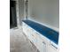 Bathroom cabinets are covered by a blue protective layer, with a view of two doorways at 1021 Azalea Garden Cir, Raleigh, NC 27603
