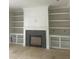 A living room is designed with built-in white shelving and a fireplace at 1021 Azalea Garden Cir, Raleigh, NC 27603