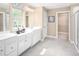 Bright bathroom featuring dual vanities, white cabinetry, and ample counter space with stylish fixtures at 1044 Country Pasture Cv, Wendell, NC 27591