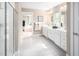Clean bathroom featuring dual vanities, white cabinetry, and ample counter space with stylish fixtures at 1044 Country Pasture Cv, Wendell, NC 27591